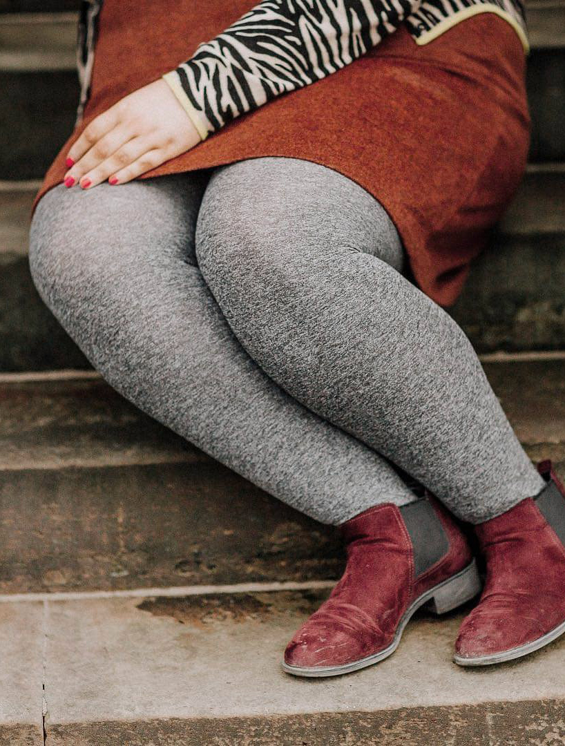 Dettaglio gambe donna con collant grigi